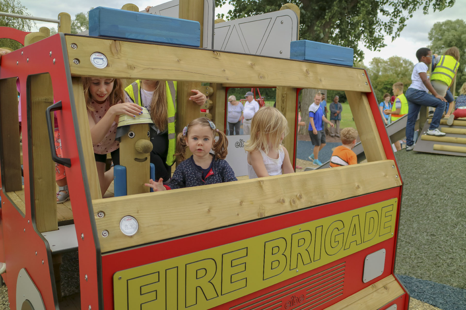 Roleplaying - Children in a play unit in the shape of a fire engine by eibe.