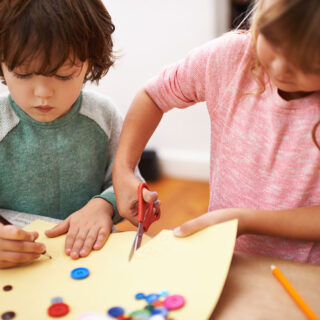 Encouraging fine motor skills - a girl and a boy doing handicrafts.